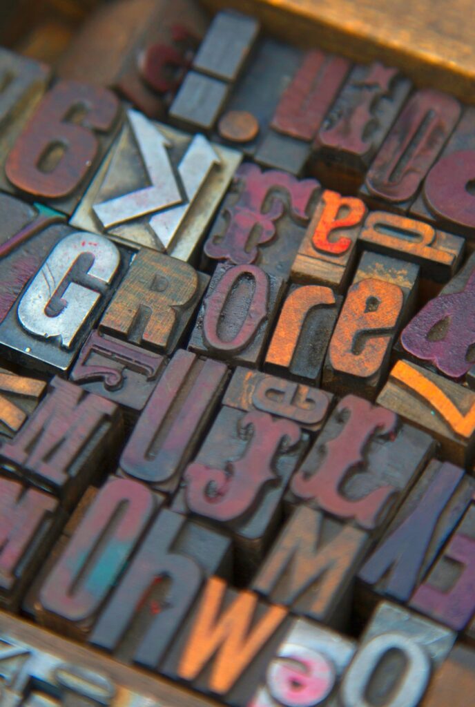 High angle close up of a selection of wood print keys in a variety of fonts.